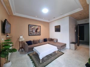 a living room with a couch and a tv at Perle studio lac 2 tunisia mall in Tunis