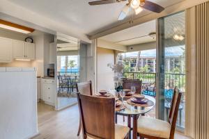 a kitchen and dining room with a table and chairs at Hale Ono Loa 204 in Lahaina