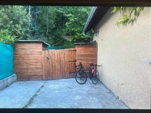 a bike parked next to a wooden fence at Chambre Morgon in Savines