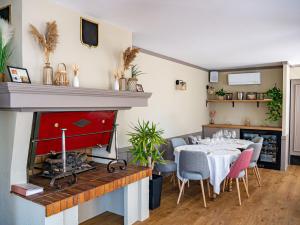 a dining room with a table and a fireplace at Maison Jean le Bon in Dax