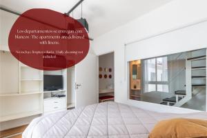 a bedroom with a large bed and a red orb at Syrah Studios in Buenos Aires