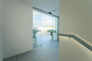 an empty room with a glass door and a balcony at Apartamentos Aires de Conil in Conil de la Frontera