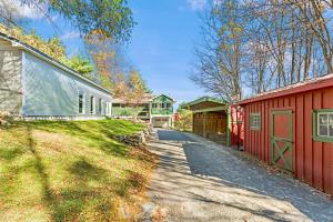 an empty driveway between two houses and a barn at Heritage Hollow in Cambridge