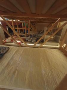 a bunk bed with wooden frame in a room at Хостел Rest Sguear in Almaty