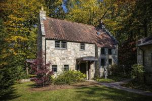 an old stone house in the middle of the woods at Storybook Three Cottage Mountain Compound in Banner Elk