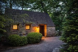 a stone house with a door in the yard at Storybook Three Cottage Mountain Compound in Banner Elk