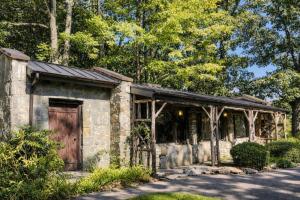 an old stone building with a wooden door at Storybook Three Cottage Mountain Compound in Banner Elk