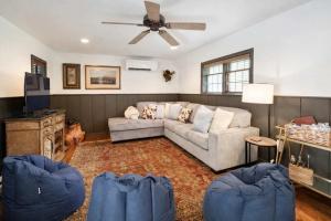 a living room with a couch and a ceiling fan at Storybook Three Cottage Mountain Compound in Banner Elk +8 photos