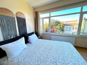 a bedroom with a bed and a large window at Kuzguncuk View in Istanbul