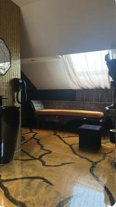 a living room with a couch and a window at Love Room in Canteleu