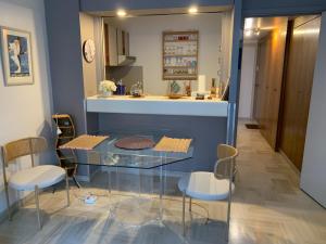 a dining room with a glass table and chairs at Gray d' Albion Apartment in Cannes