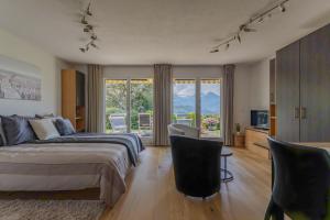 a bedroom with a bed and a sliding glass door at Ferienwohnung Schwyz in Schwyz