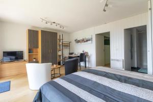 a bedroom with a bed and a living room at Ferienwohnung Schwyz in Schwyz