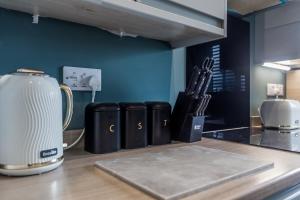a kitchen counter with a blender and utensils at 61 Deneside in Lanchester