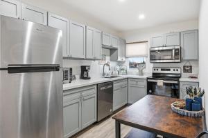 a kitchen with white cabinets and a stainless steel refrigerator at 2 Bedroom Unit in Corpus Christi