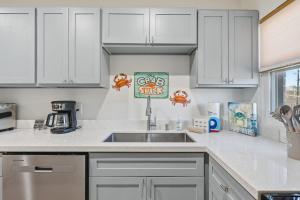 a kitchen with white cabinets and a sink at 2 Bedroom Unit in Corpus Christi +10 photos