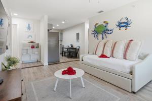 a living room with a white couch and a table at 2 Bedroom Unit in Corpus Christi