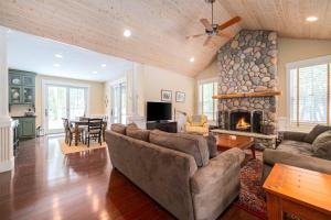 a living room with a couch and a fireplace at Pine Trace Escape in Glen Arbor in Glen Arbor