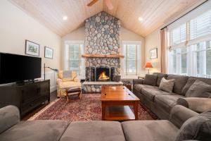 a living room with a couch and a fireplace at Pine Trace Escape in Glen Arbor in Glen Arbor