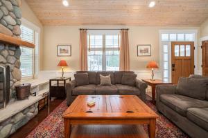a living room with a couch and a coffee table at Pine Trace Escape in Glen Arbor in Glen Arbor