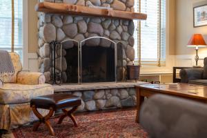 a living room with a large stone fireplace at Pine Trace Escape in Glen Arbor in Glen Arbor
