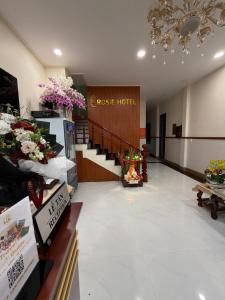 a lobby of a hotel with flowers on display at Rosie Hotel in Da Thien