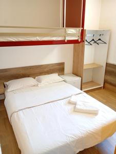 a bed in a room with two bunk beds at HOTEL THANIA Sète Frontignan in Frontignan