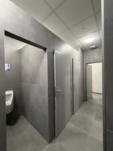 a bathroom with a toilet and a urinal and a sink at Penzion BETA in Třebíč +40 photos