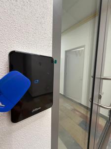 a glass door with a blue object in a room at Penzion BETA in Třebíč