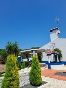 a church with a chapel and trees in front of it at Herdade da Cova da Onça in Canha