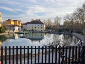a view of a river with buildings and a fence at LILI Deluxe Apartman in Tapolca