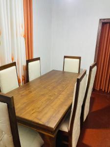 a dining room table with chairs around it at Tea Leaf Family Cottage in Bandarawela