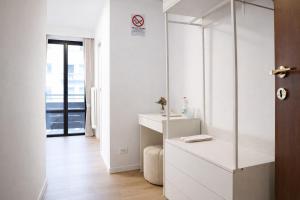 a white bathroom with a sink and a mirror at Sunshine HOTEL in Mestre