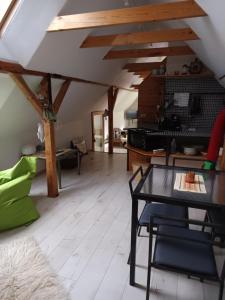 a living room with a table and a piano at Historický objekt Ailit in Podbranč