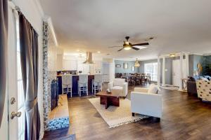 a living room and kitchen with a couch and a table at Poolside Bliss! Christian Pass Family Home w/ Yard in Long Beach