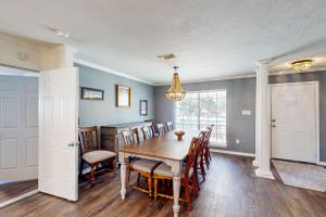 a dining room with a table and chairs at Poolside Bliss! Christian Pass Family Home w/ Yard in Long Beach