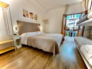 a bedroom with two beds and a window at Hotel S. Ercolano in Perugia