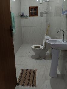 a bathroom with a toilet and a sink at Recanto Família lima e Silva in Garanhuns +25 photos