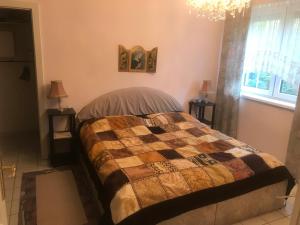 a bedroom with a bed and two lamps and a chandelier at Ferienhaus Marhardt in Oslip