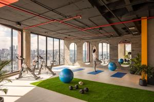 a yoga studio with people doing yoga in a room with windows at Top Rentals EpiQ in Quito