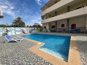 a swimming pool with a chair next to a building at mountain Luxor in Al Aqālitah
