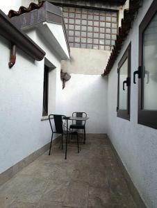 a patio with two chairs and a table in a building at Rota's House III in Bergamo