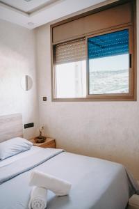 a bedroom with two beds and a window at Shaka Ashore Imsouane in Imsouane
