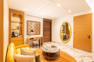 a living room with a yellow couch and a table at Garza Blanca Sanctuary Puerto Vallarta in Puerto Vallarta +30 photos