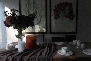 a dining room table with a vase of flowers on it at Villa Čisovice - Functionalist Retreat near Prague in Čisovice