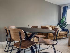 a table and chairs in a living room with a couch at Le Croizat - Neyrpic in Saint-Martin-dʼHères +43 photos