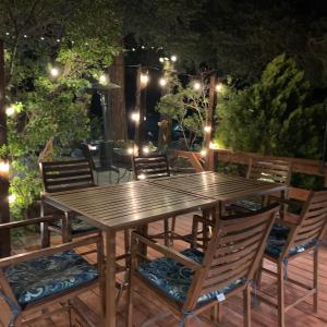 a wooden table and chairs on a patio at night at Virginia Creek Settlement in Bridgeport +43 photos
