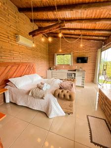 a room with two beds and a kitchen in it at Chalés Aconchego dos Canyons in Praia Grande