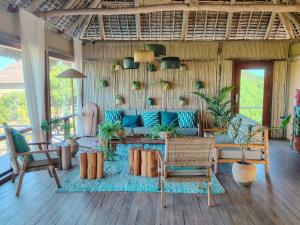 a living room with a blue couch and chairs at Travessia Beach Lodge in Inhambane