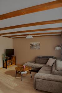 a living room with a couch and a coffee table at Chalet Aloa in Adelboden